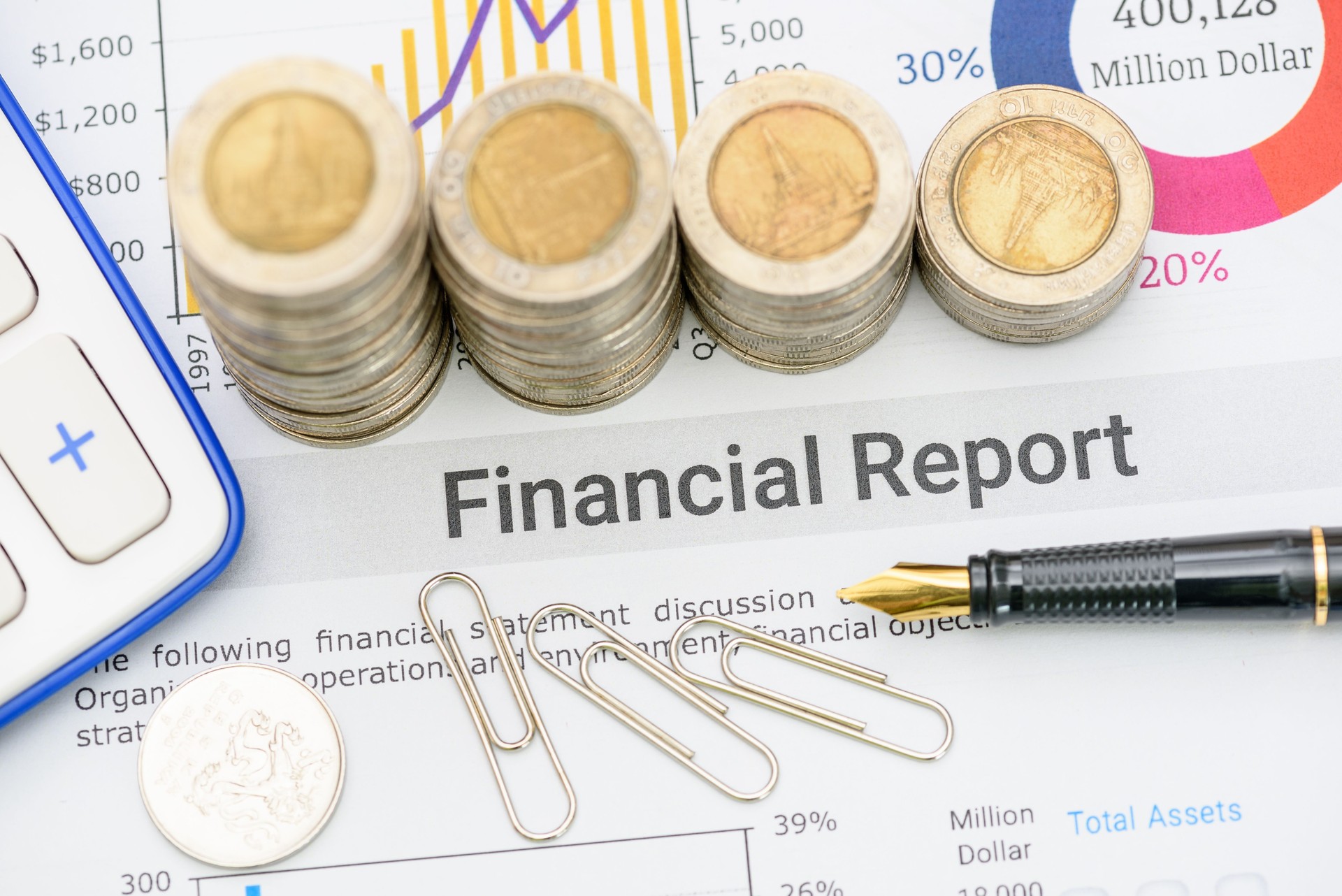 Pen atop a business or corporate financial report, anticipating review by financial and investment experts prior to public disclosure. Illustrating financial analysis and investment insight concept.