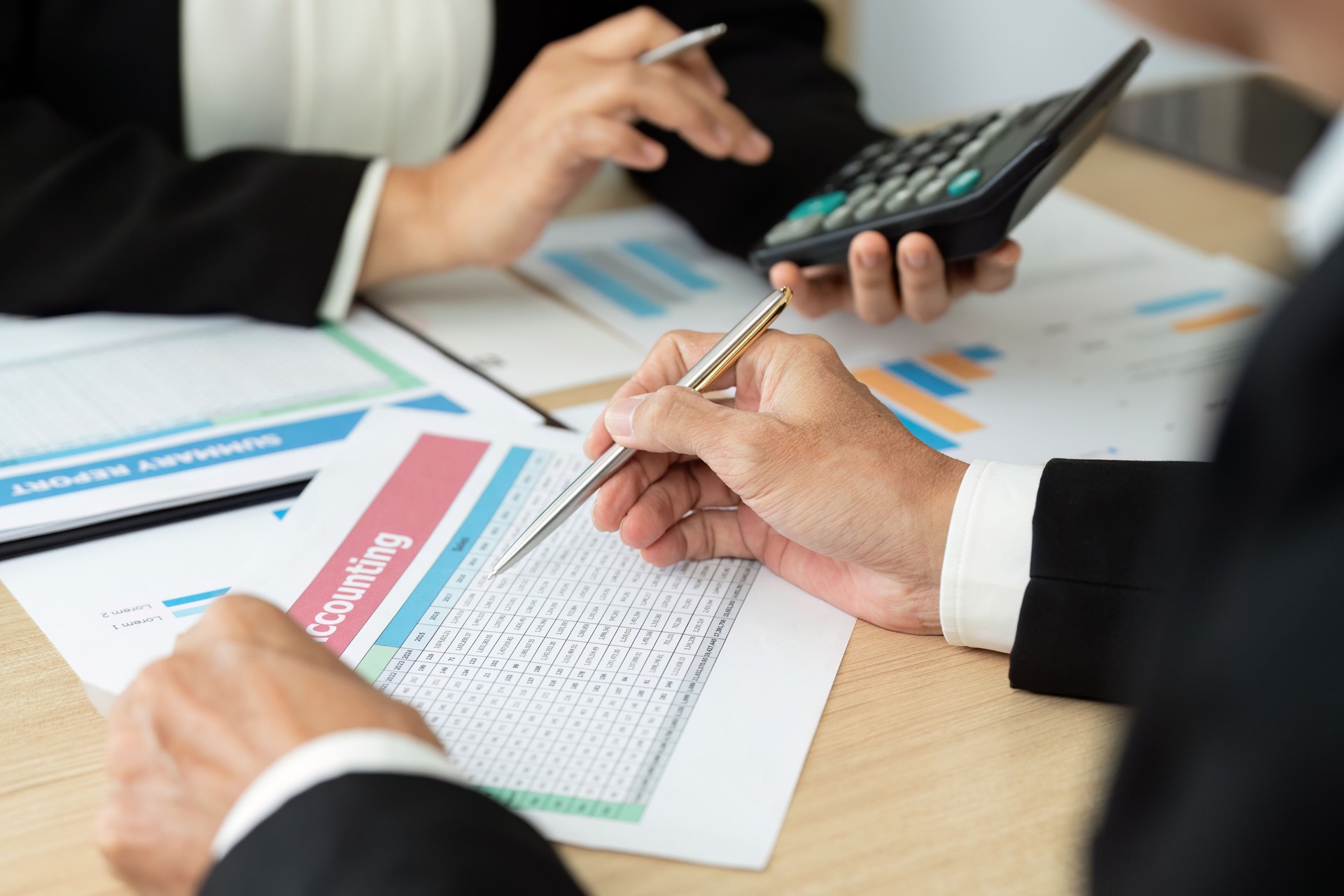 Business Meeting on Financial Reports. Professionals discussing accounting data.